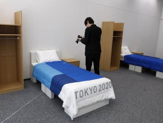 A journalist films a cardboard bed in the Tokyo 2020 Olympic and Paralympic Villages. Picture: Jae C Hong/AP