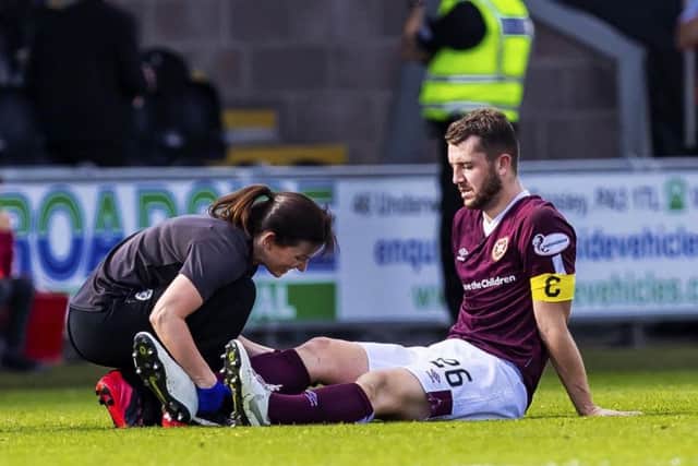Hearts physio Karen Gibson attends to Craig Halkett after the defender sustained an injury during their Premiership clash against St Mirren in September, which resulted in him being out of actrion for more then two months. Picture: SNS.