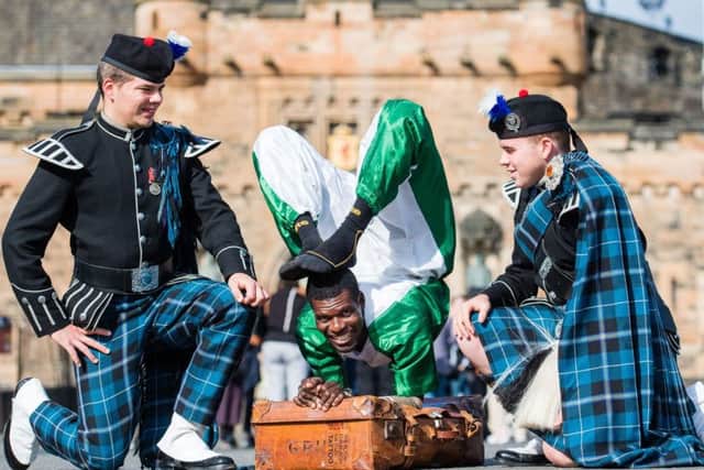 Adam Hill and Cameron O'Neill, of Pipers Trail, with Nigerian contortionist Aminu Haladu at last year's Royal Edinburgh Military Tattoo (Picture: Ian Georgeson)