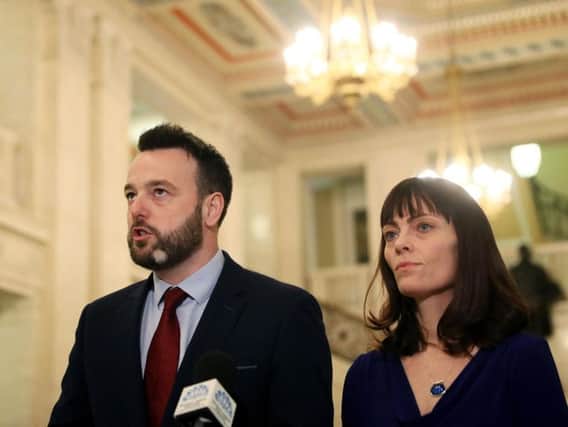 SDLP leader Colum Eastwood (left) and deputy leader Nichola Mallon speak to the media in the Great Hall of Parliament Buildings,