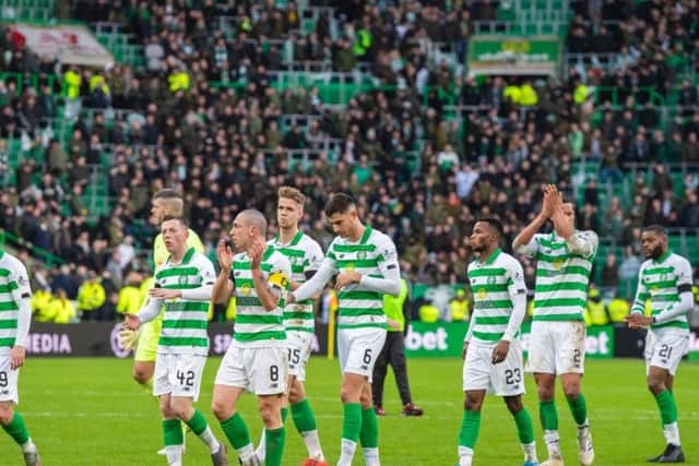 The Celtic players applaud the fans at the end of the Old Firm clash in December