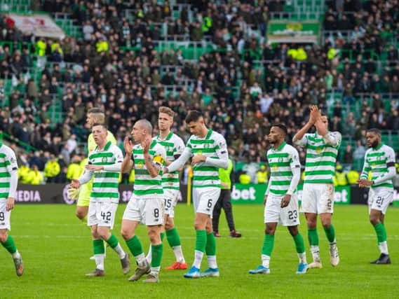The Celtic players applaud the fans at the end of the Old Firm clash in December