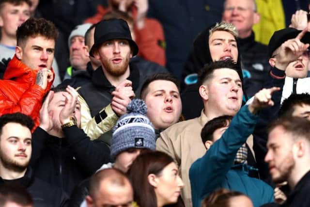 Oli McBurnie (in black hat) attends the Cardiff City v Swansea City derby