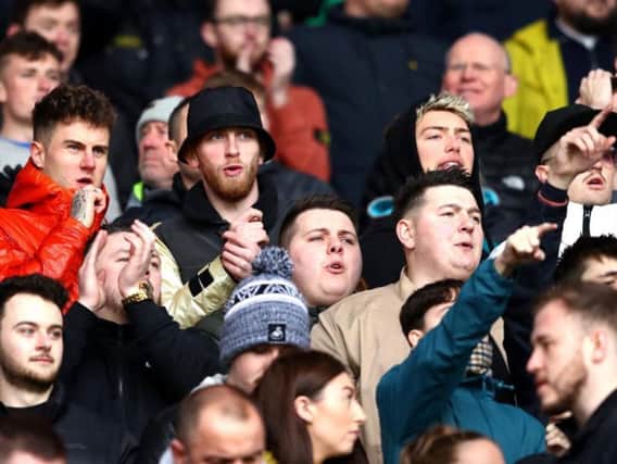 Oli McBurnie (in black hat) attends the Cardiff City v Swansea City derby