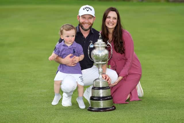 Branden Grace shows off the trophy along with his wife Nieke and their son, Roger. Picture: Getty.