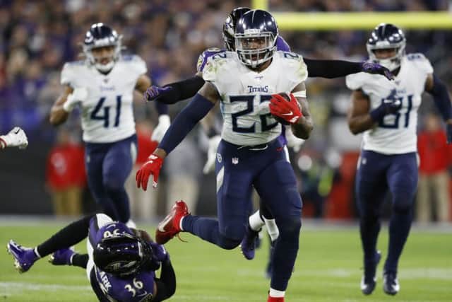 Tennessee Titans running back Derrick Henry skips past Baltimore Ravens strong safety Chuck Clark. Picture: Julio Cortez/AP
