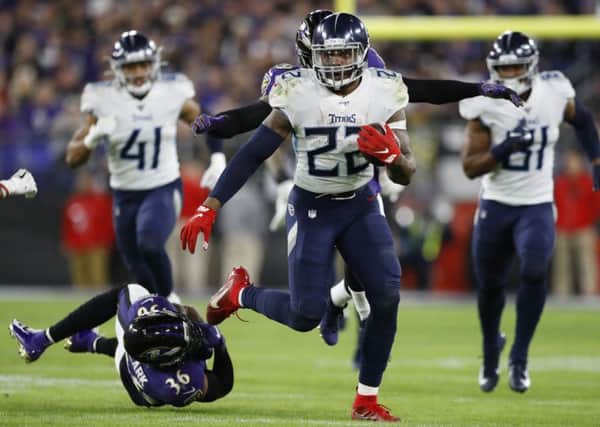 Tennessee Titans running back Derrick Henry skips past Baltimore Ravens strong safety Chuck Clark. Picture: Julio Cortez/AP
