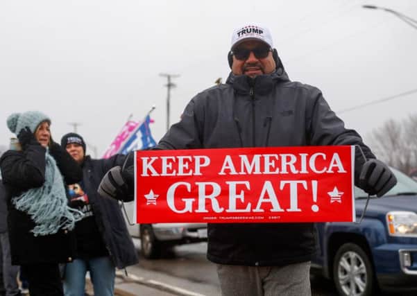 A Trump supporter holds a sign that reads "Keep America Great", a reference to the US President's election campaign slogan "Make America Great Again" during a rally in Joliet, Illinois. (Picture: Joshua Lott/AFP via Getty Images)
