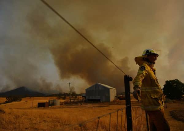 Firefighter Trevor Stewart watches a fire on in Tumburumba, Australia, on Saturday (Picture: Sam Mooy/Getty Images)
