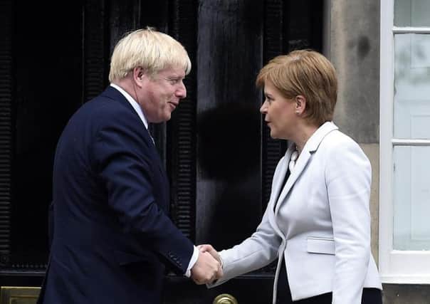 Boris Johnson and Nicola Sturgeon shake hands but relations do not appear overly friendly