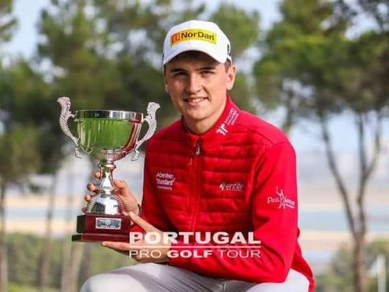 Sam Locke shows off the trophy after his win on the Portugal Pro Golf Tour
