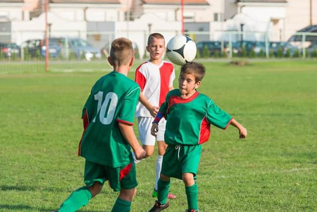 Kids can still learn proper heading technique without using a harmfully heavy ball. Picture: Shutterstock