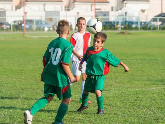Kids can still learn proper heading technique without using a harmfully heavy ball. Picture: Shutterstock