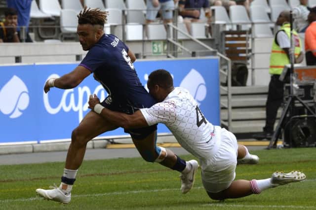 Femi Sofolarin, left, beats Englands Dan Norton to score a try during the HSBC World Rugby Sevens Series event at the Cape Town Stadium in South Africa. Picture: Rodger Bosch/AFP/Getty