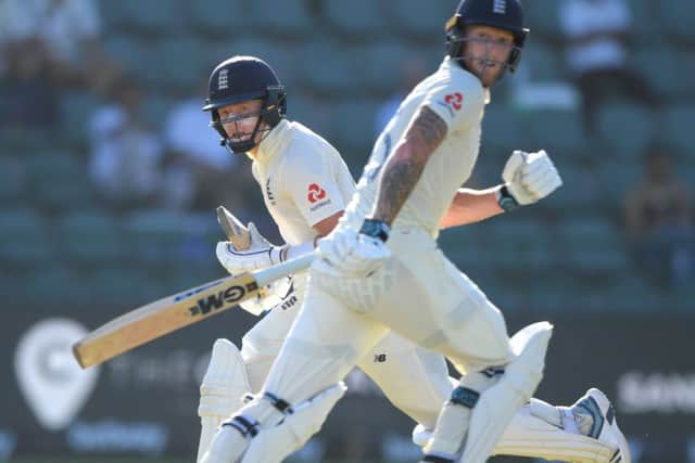 England batsmen Ollie Pope, left, and Ben Stokes pick up runs om day one of the Third Test against South Africa at St Georges Park. Picture: Stu Forster/Getty