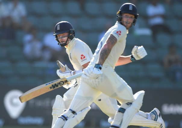 England batsmen Ollie Pope, left, and Ben Stokes pick up runs om day one of the Third Test against South Africa at St Georges Park. Picture: Stu Forster/Getty