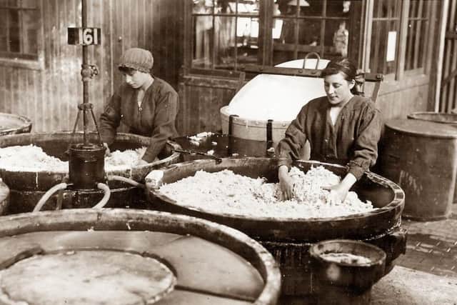 Women unloading nitrating pans at the factory. PIC: Courtesy of The Devil's Porridge Museum.