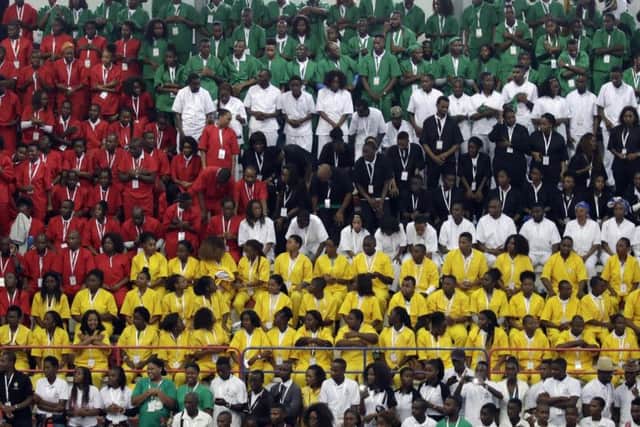Youths wearing coloured shirts form the flag of Mozambique during an inter-religious meeting. Picture: Associated Press