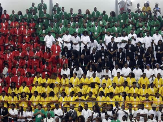 Youths wearing coloured shirts form the flag of Mozambique during an inter-religious meeting. Picture: Associated Press