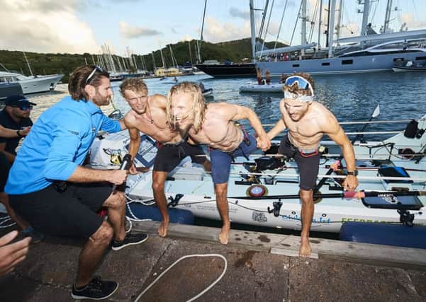 Lachlan, 21, Jamie, 26, and Ewan, 27, (from left to right) celebrate their arrival in Antigua. (Picture: Atlantic Campaigns /SWNS.com)