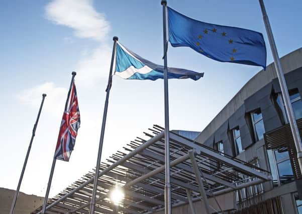 The Scottish Saltire, the Union Jack and the flag of the European Union fly outside the Scottish Parliament (Picture: Neil Hanna)