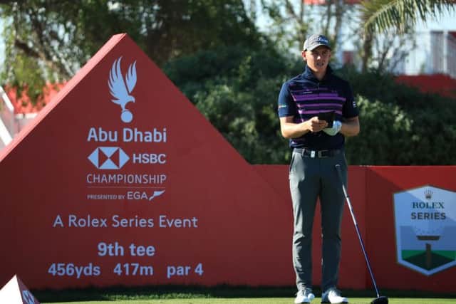 Grant Forrest checks his yardage book during the second round of the Abu Dhabi HSBC Championship