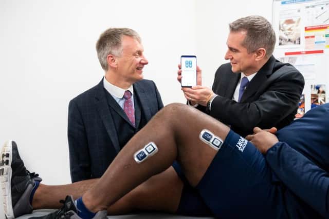 MSP Ivan McKee (left) with Roman Bensen, CEO of EnMovi, looking at EnMovi's MotionSense product. Picture: Stuart Wallace