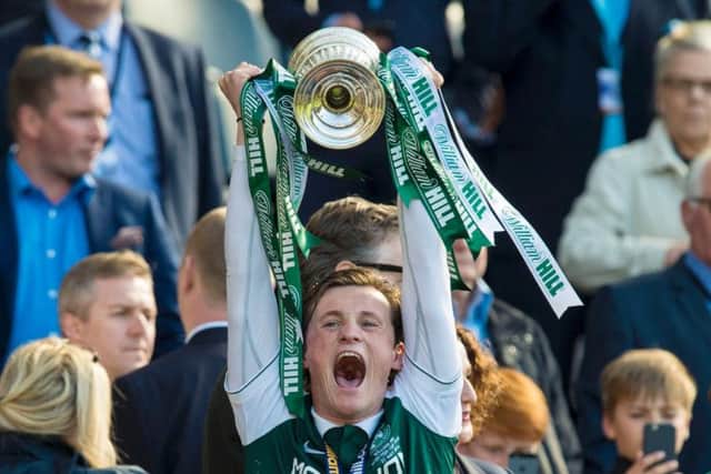 Liam Henderson holds aloft the Scottish Cup.