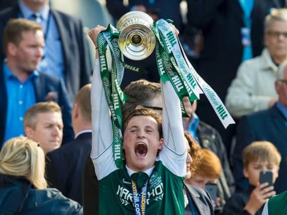 Liam Henderson holds aloft the Scottish Cup.