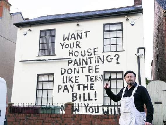 Painter and decorator, Dean Reeves took revenge by painting the message on the side of the pub. Picture: SWNS