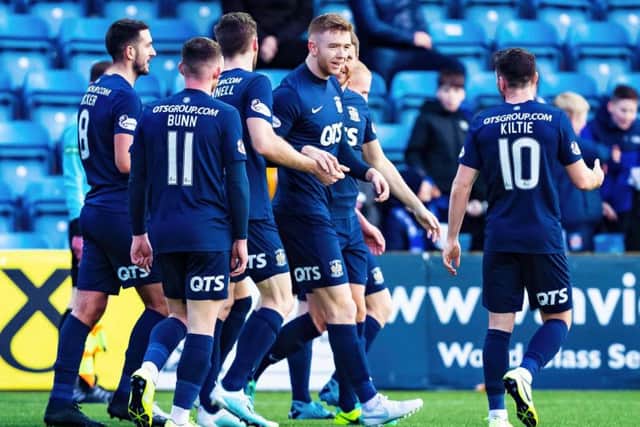 Stuart Findlay celebrates scoring with his teammates.
