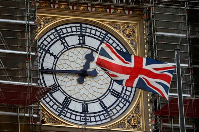 The Union flag flutters near the clockface of Big Ben during ongoing renovations to the Tower. Picture: AFP
