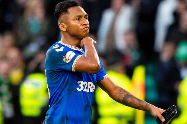 Alfredo Morelos makes a cut-throat gesture after being sent off against Celtic. Picture: SNS