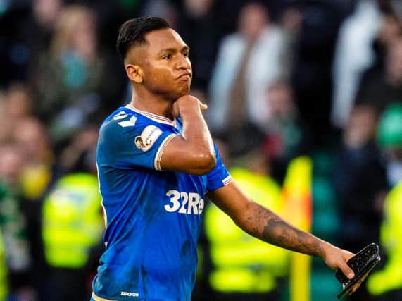 Alfredo Morelos makes a cut-throat gesture after being sent off against Celtic. Picture: SNS