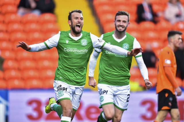 Christian Doidge celebrates after his goal opened the scoring for Hibs at Tannadice. Picture: SNS.