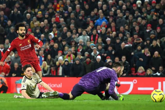 Mo Salah watches his shot slide past David de Gea to seal Liverpools 2-0 victory at Anfield. Picture: Getty