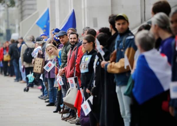 Demonstrators create a human chain from Parliament Square to Downing Street to call on the Government to clarify the position of EU nationals living in the UK after Brexit (Picture: Tolga Akmen/AFP/Getty Images)