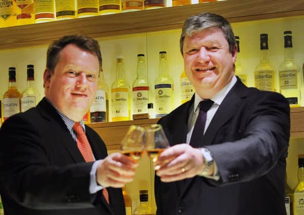 David Frost, left, raises a glass with former Scottish Secretary Alistair Carmichael during his stint at the Scotch Whisky Association (Picture: Steven Scott Taylor)