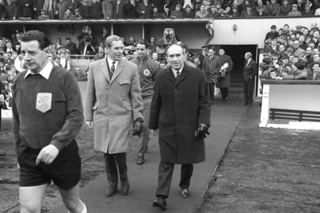 Scotland manager Bobby Brown, left, walks out with England boss Alf Ramsey at Hampden ahead of a European Championship qualifying match in 1968. Picture: PA