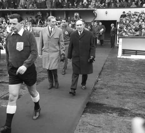 Scotland manager Bobby Brown, left, walks out with England boss Alf Ramsey at Hampden ahead of a European Championship qualifying match in 1968. Picture: PA