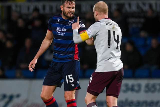 Steven Naismith has words with Ross County's Keith Watson during the match at Dingwall. Picture: SNS