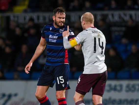 Steven Naismith has words with Ross County's Keith Watson during the match at Dingwall. Picture: SNS