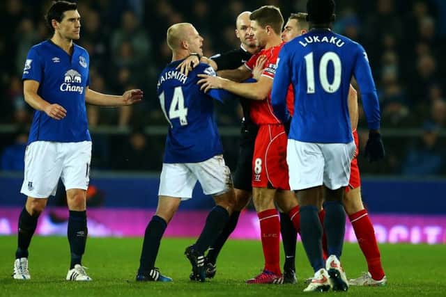 Liverpool pair Steven Gerrard and Jordan Henderson clash with Steven Naismith of Everton during a Premier League match at Goodison Park in February 2015.
