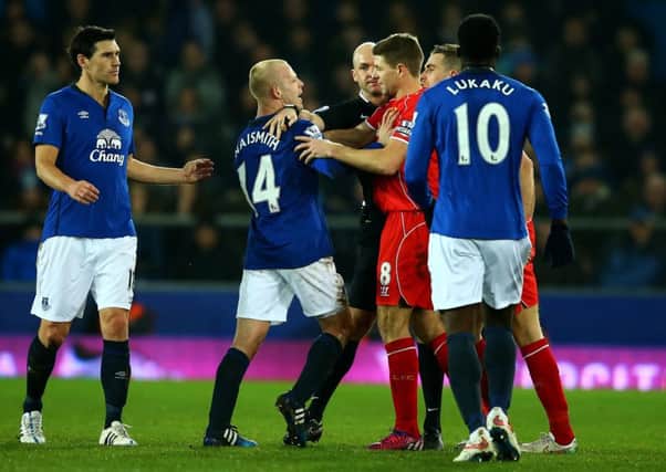 Liverpool pair Steven Gerrard and Jordan Henderson clash with Steven Naismith of Everton during a Premier League match at Goodison Park in February 2015.
