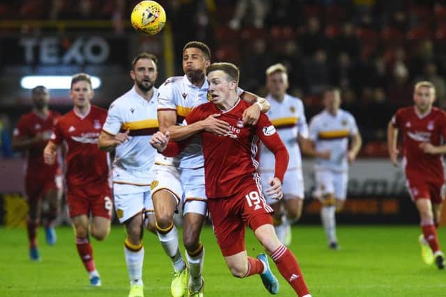 Lewis Ferguson battles for the ball against Motherwell.