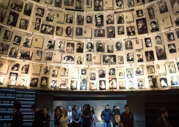 People visit the Hall of Names in Israel's Yad Vashem Holocaust museum  (Picture: Lior Mizrahi/Getty Images)