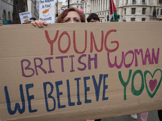 People outside Downing Street in central London take part in a protest march in support of the British woman convicted in Cyprus of lying about being gang-raped.