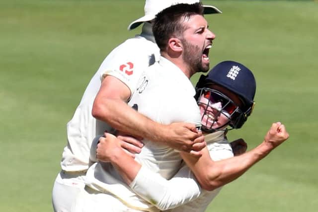Mark Wood celebrates with Ollie Pope after taking the wicket of Rassie van der Dussen for 98. Picture; Lee Warren/Gallo Images/Getty Images