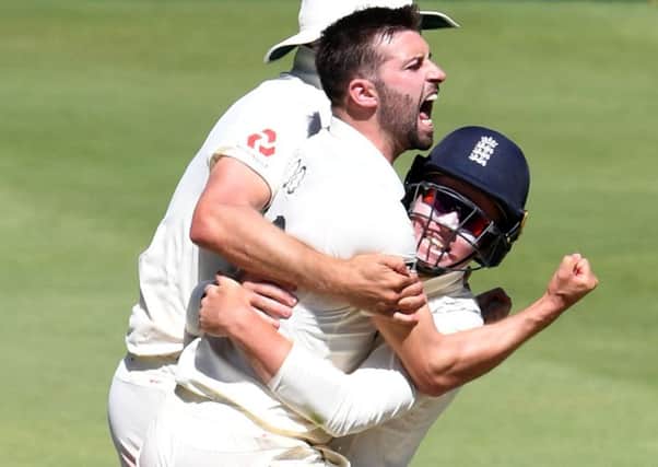Mark Wood celebrates with Ollie Pope after taking the wicket of Rassie van der Dussen for 98. Picture; Lee Warren/Gallo Images/Getty Images