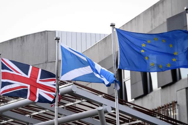 The Union Flag, Saltire and EU flag fly over Holyrood. Picture: Andy Buchanan